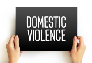 Domestic Violence is violence or other abuse that occurs in a domestic setting, such as in a marriage or cohabitation, text concept on card