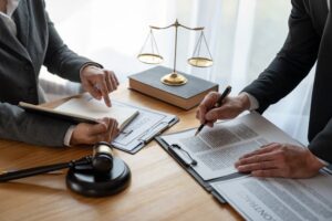 Lawyer and businessman reviewing contract details for legal accuracy and joint financial investment.