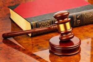 the gavel of a judge in court. lies on a desk.