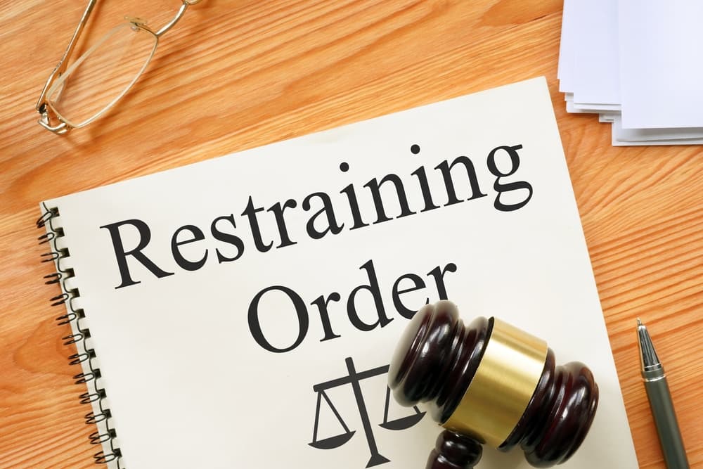 Restraining Order is shown on a photo using the text
