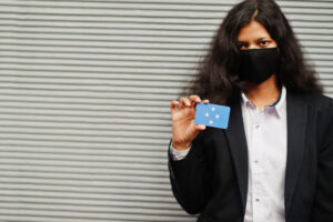 Person displaying ID card to represent identity fraud and need for Las Vegas identity theft defense lawyer