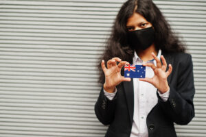 Woman wearing mask holding identification card, symbolizing identity theft case handled by Las Vegas identity theft lawyer