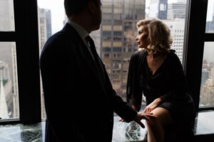 Man and woman in an intimate setting by a window, representing a statutory sexual seduction scenario in Las Vegas.